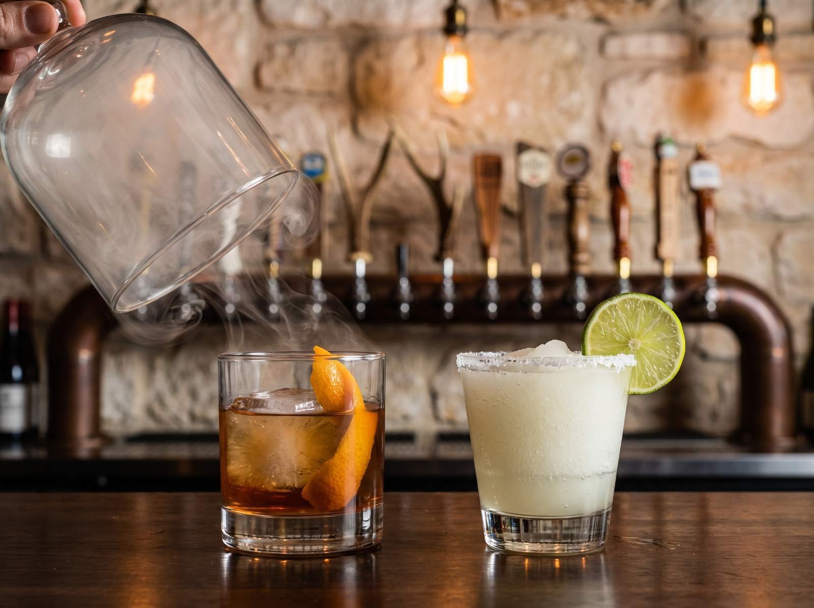 A smoked old fashioned and a frozen margarita on the bar